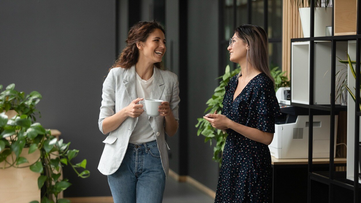 two-women-walking-and-laughing